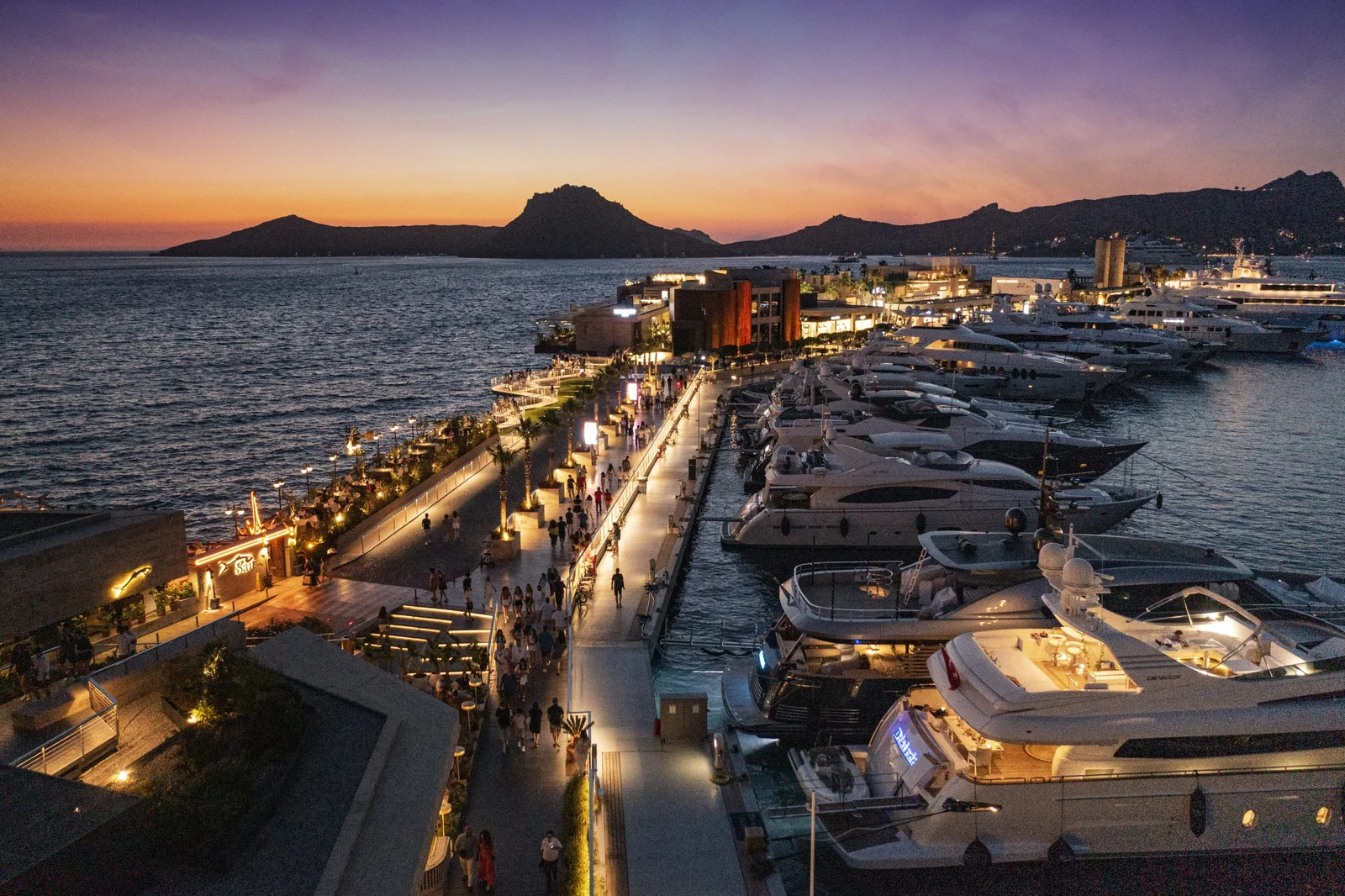 Yalıkavak Palmarina luxury superyacht marina Bodrum at sunset with mega yachts, high-end restaurants, designer boutiques on Turkish Riviera