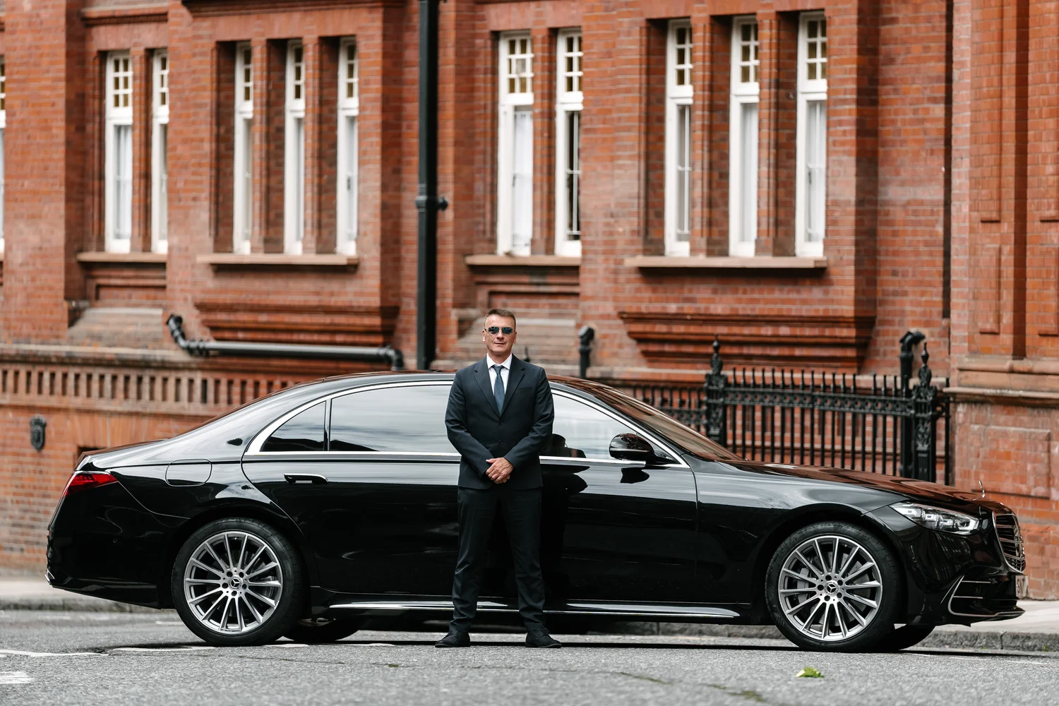 BYZAS professional English-speaking chauffeurs in formal attire standing beside Mercedes-Benz S-Class luxury fleet Turkey VIP transportation